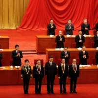 Chinese President Xi Jinping poses with respiratory disease expert Zhong Nanshan (second from right) and other medical experts during a meeting to commend role models in China\'s fight against COVID-19 at the Great Hall of the People in Beijing in September.  | REUTERS 