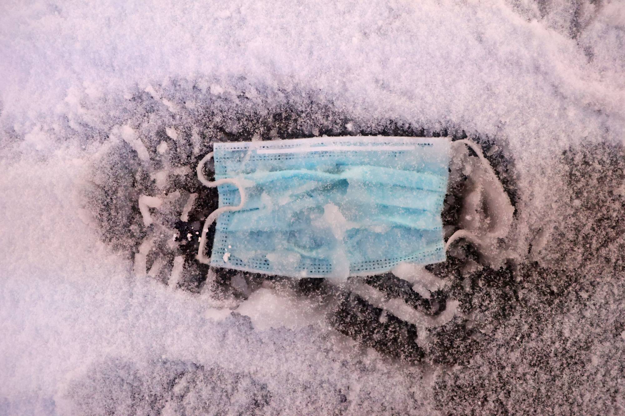 A face mask lies on the ground in New York in December. | REUTERS