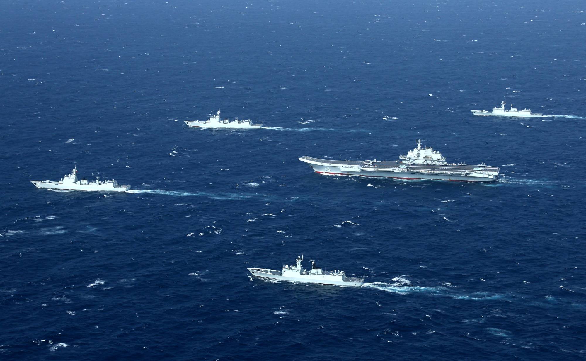 China's Liaoning aircraft carrier with accompanying vessels conducts a drill in the disputed South China Sea in December 2016. | REUTERS