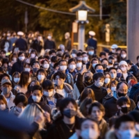 People line up to offer New Year\'s prayers at Meiji Shrine on Friday in Tokyo. | AFP-JIJI