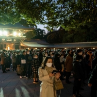 People offer prayers at Meiji Shrine in Tokyo on New Year\'s Day. Tokyo reported 841 new COVID-19 cases on Saturday amid an uptick in the number of infections. | AFP-JIJI