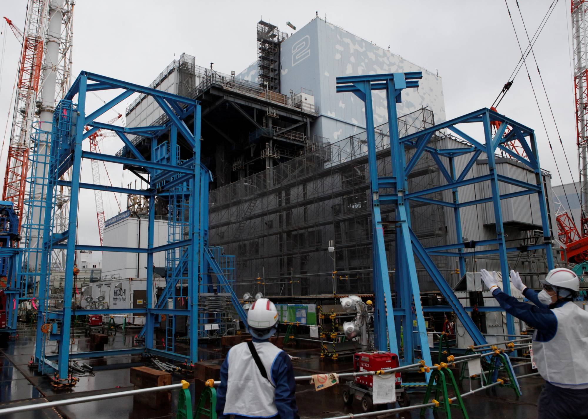 Workers are seen last year near the No. 2 reactor building at the disaster-hit Fukushima No. 1 nuclear plant. | REUTERS