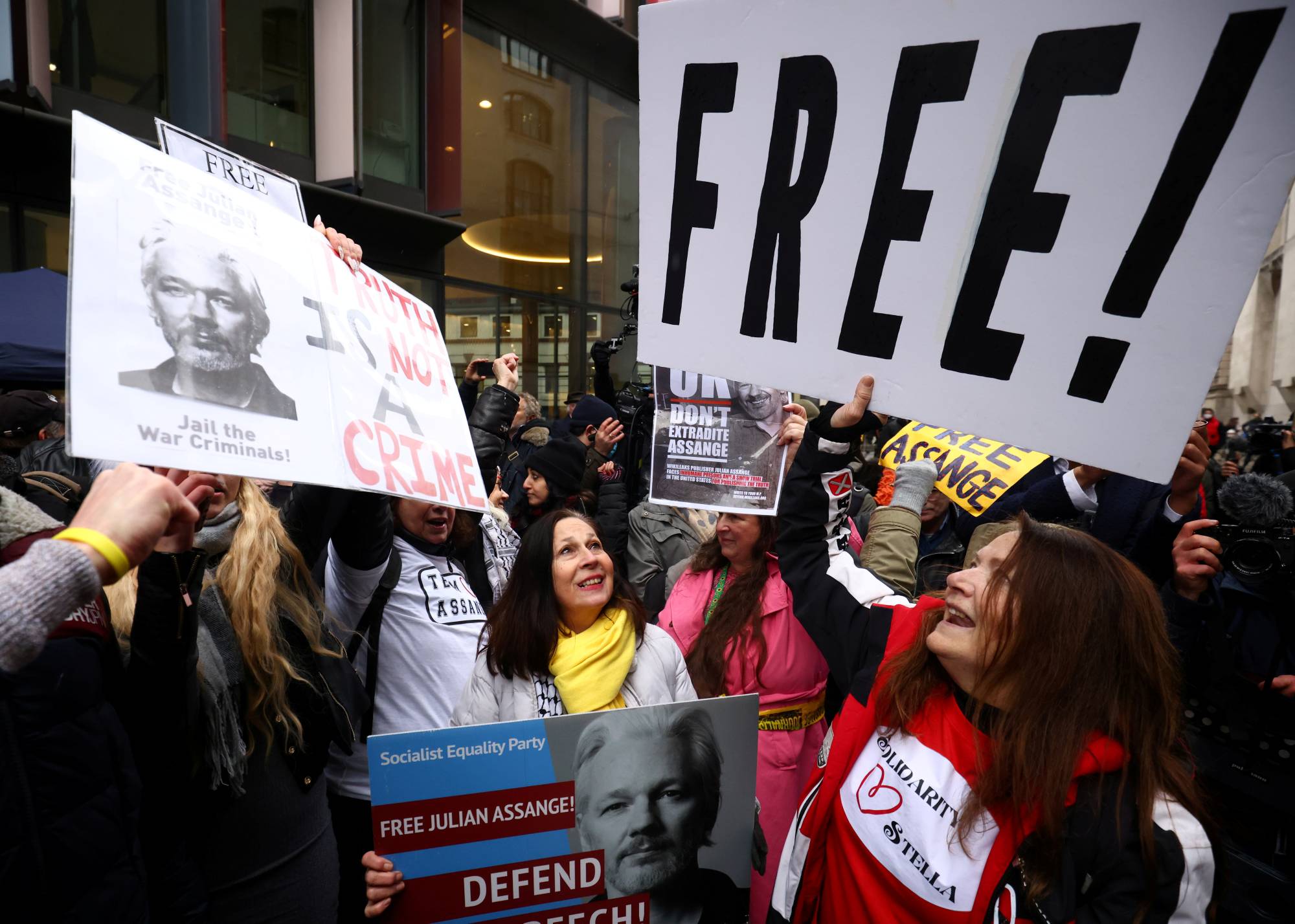 People celebrate outside the Old Bailey in London after a judge ruled Monday that WikiLeaks founder Julian Assange should not be extradited to the U.S. |  REUTERS
