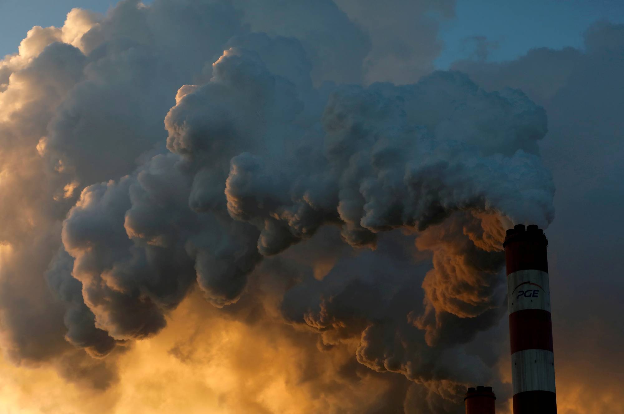 Smoke and steam billow from the Belchatow Power Station, Europe's largest coal-fired power plant, near Belchatow, Poland. The most significant climate law last year was the EU setting a legally binding target to reach net-zero emissions by 2050. | REUTERS