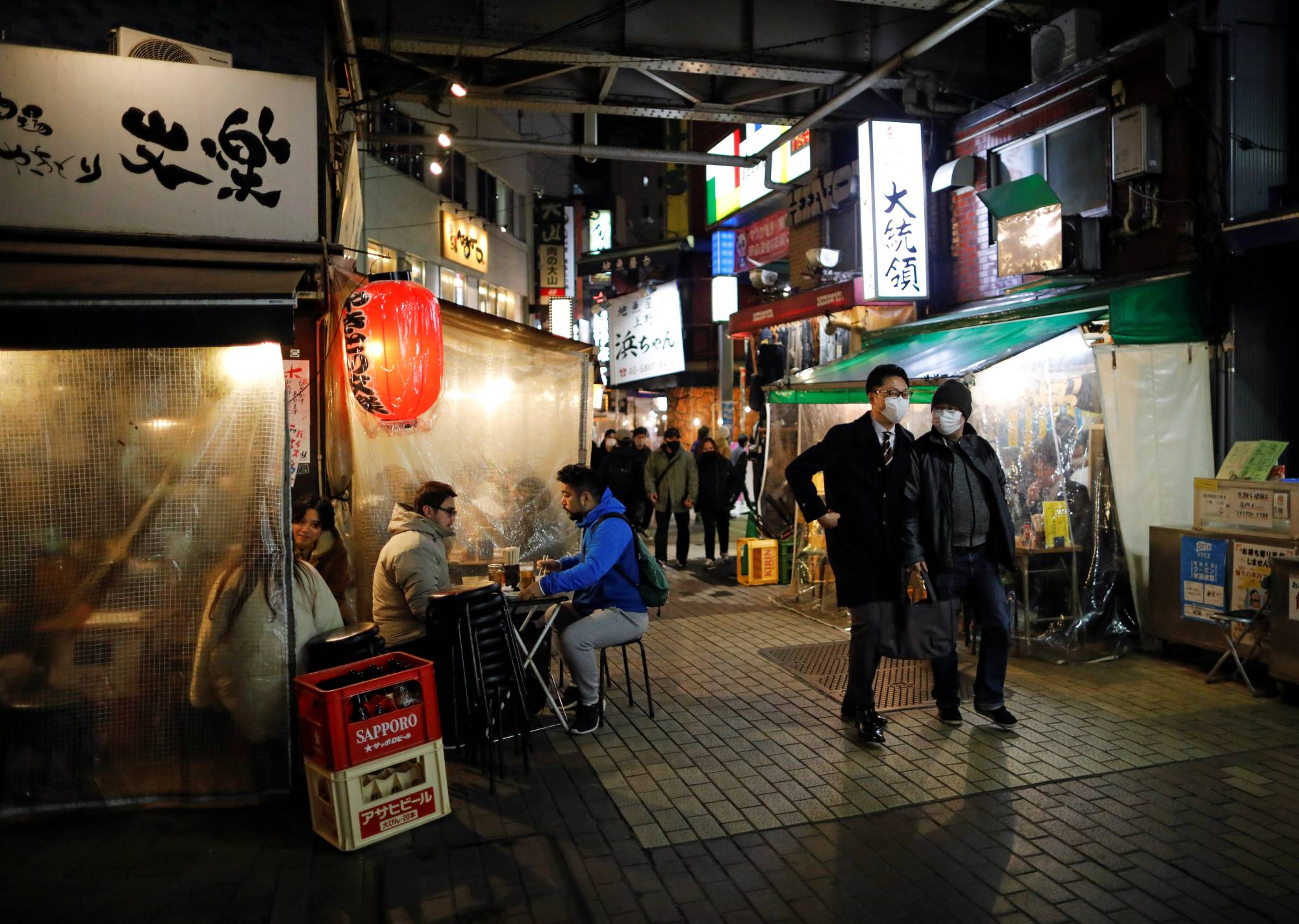 People enjoy drinking and dining at an izakaya-style pub amid the COVID-19 outbreak in Tokyo on Tuesday. | REUTERS