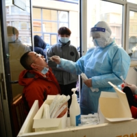 Mass nucleic acid testing is carried out following a recent coronavirus disease (COVID-19) outbreak in China\'s Hebei province, on Jan. 6. | CHINA DAILY / VIA REUTERS