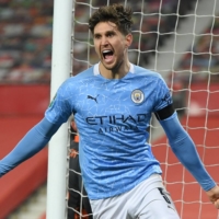 Manchester City\'s John Stones celebrates after scoring against Manchester United in the League Cup semifinals on Wednesday in Manchester, England. | POOL / VIA REUTERS