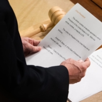 U.S. Vice President Mike Pence reads a sheet of paper with the final Electoral College vote counts declaring Joe Biden the next U.S. President during a joint session of Congress at the Capitol in Washington on Thursday. | AFP-JIJI