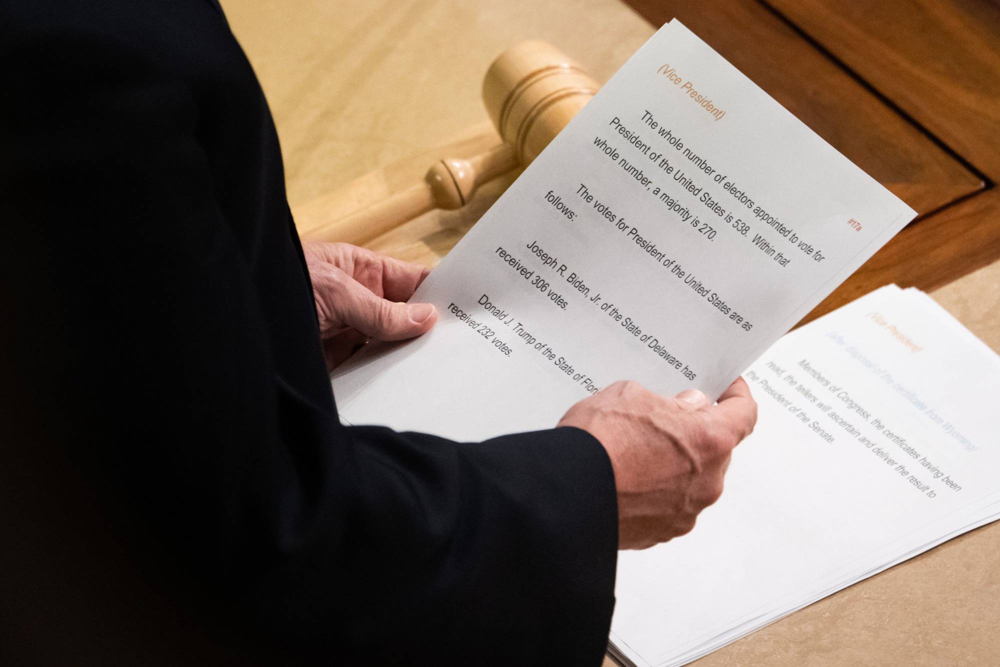 U.S. Vice President Mike Pence reads a sheet of paper with the final Electoral College vote counts declaring Joe Biden the next U.S. President during a joint session of Congress at the Capitol in Washington on Thursday. | AFP-JIJI