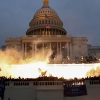 An explosion caused by a police munition is seen while supporters of U.S. President Donald Trump gather in front of the U.S. Capitol in Washington on Wednesday.  | REUTERS