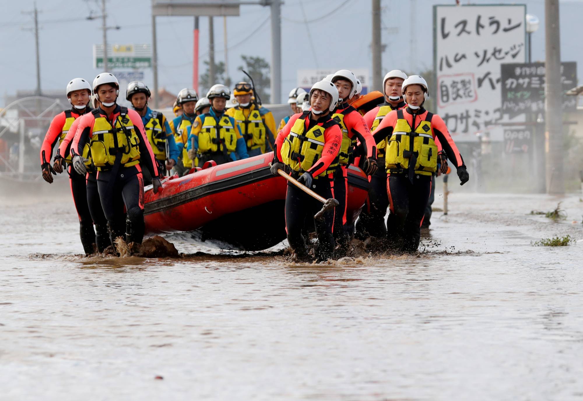 Rescue workers search a flooded area in the aftermath of Typhoon Hagibis, which caused severe floods at the Chikuma River in Nagano Prefecture in October 2019. | REUTERS