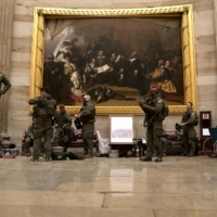 Police in riot gear sit in the rotunda of the U.S. Capitol in Washington on Wednesday.  | BLOOMBERG 