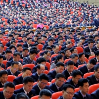 Attendees take notes during a ruling Workers\' Party of Korea Congress in Pyongyang on Saturday. | KCNA / KNS / VIA AFP-JIJI