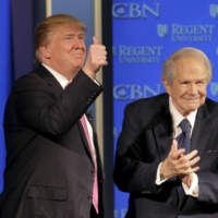 Donald Trump, then-U.S. Republican presidential candidate, acknowledges the audience after speaking with Pat Robertson at a campaign event at Regents University in Virginia Beach, Virginia, in February 2016. The deep-pocketed conservative \"religious right,\" boasting megachurch leaders who speak to millions, like Christian Broadcasting Network founder Robertson, has had a strong influence on politics in recent decades. | REUTERS