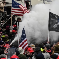 A supporter of U.S. President Donald Trump sprays smoke outside of the Capitol building in Washington last Wednesday.  | REUTERS 