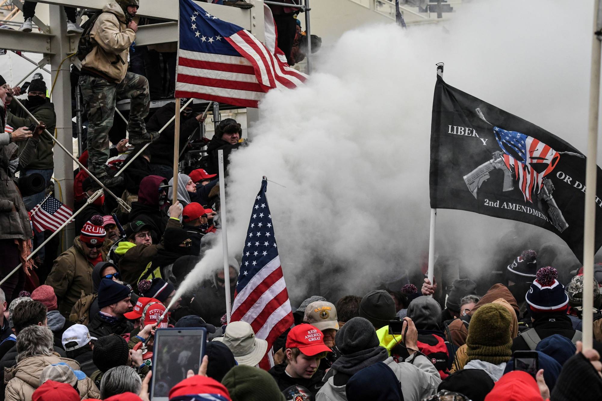 A supporter of U.S. President Donald Trump sprays smoke outside of the Capitol building in Washington last Wednesday. | Reuters 