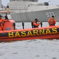 A search and rescue team conducts operations near Lancang Island on Sunday.  | AFP-JIJI