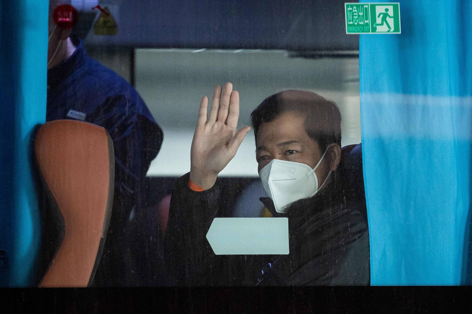 A member of the World Health Organization team investigating the origins of the COVID-19 pandemic sits on a bus following the team's arrival in Wuhan on Thursday. | AFP-JIJI
