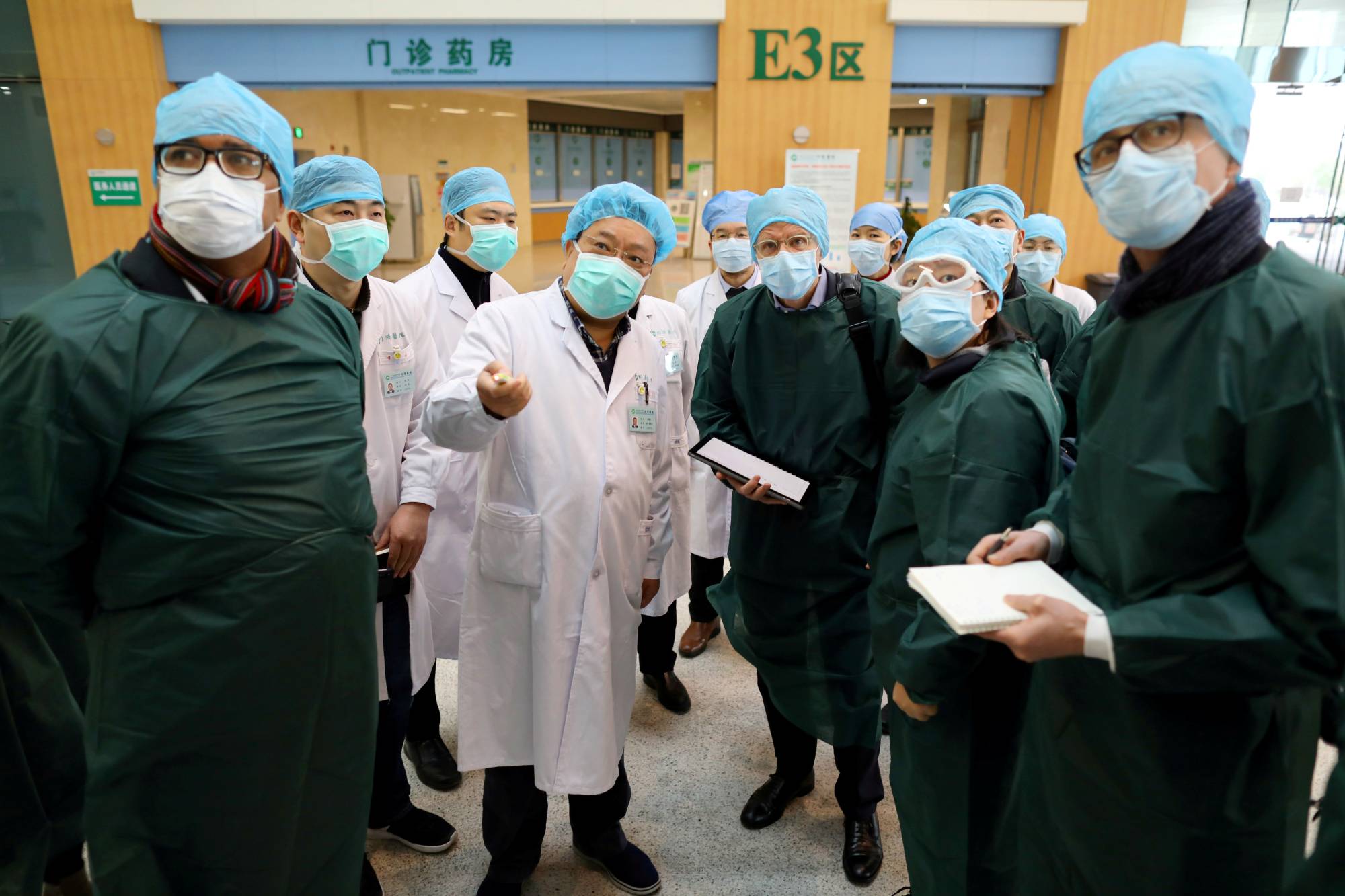 Experts from China and a World Health Organization team visit Wuhan Tongji Hospital in February last year.  | China Daily / via REUTERS