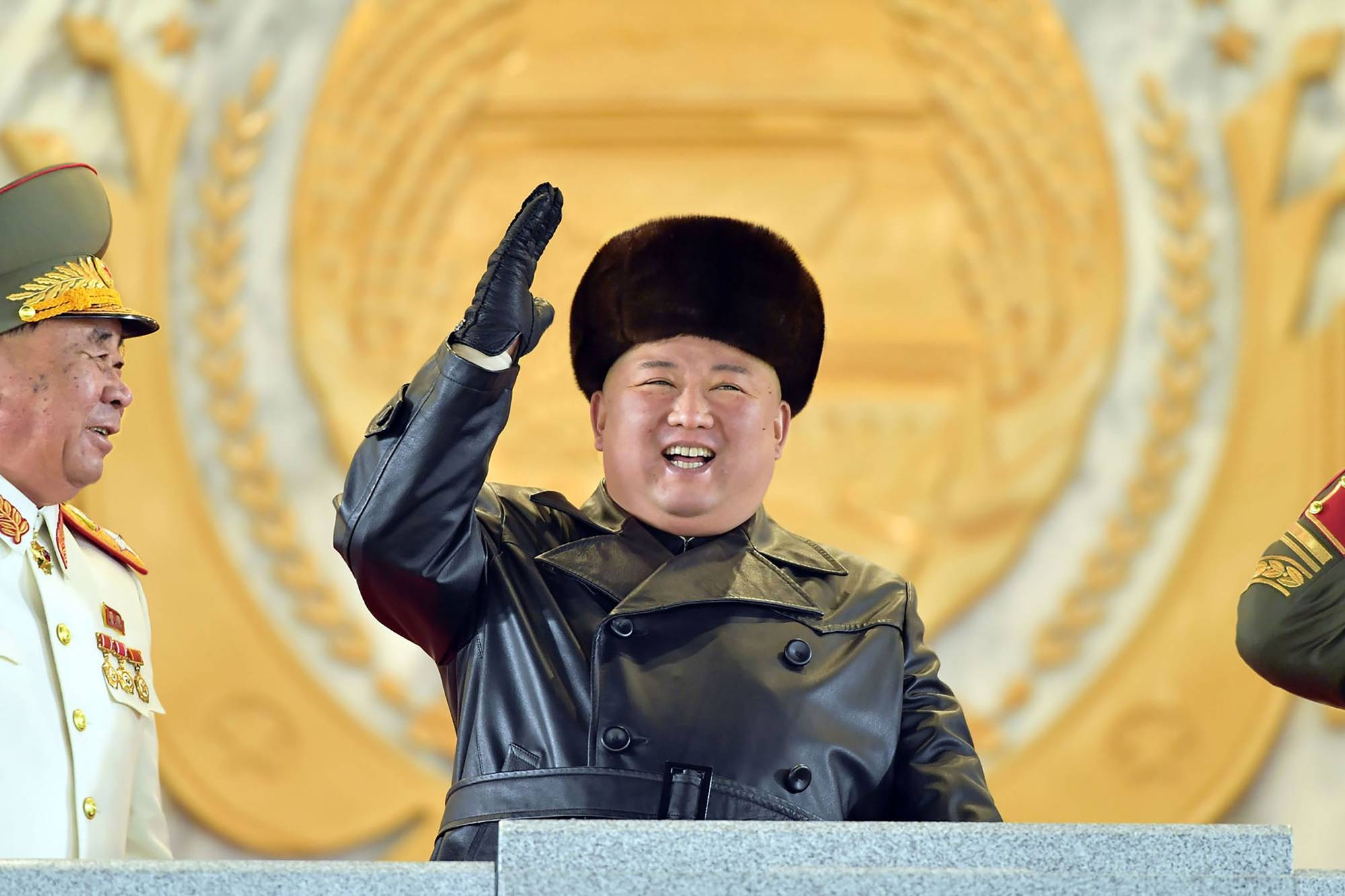 North Korean leader Kim Jong Un waves from a stage during a military parade celebrating a ruling Workers' Party of Korea congress in Pyongyang on Thursday. | KCNA / KNS / VIA AFP-JIJI