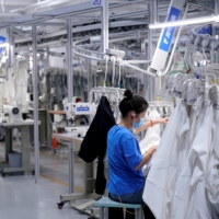 A worker works at a factory in Hangzhou, Zhejiang province, China, in November. Multinational companies have another reason for sticking with or even adding to their investments in China: the fast-growing consumer market. | REUTERS