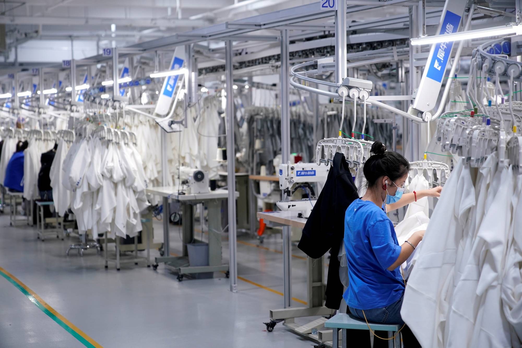 A worker works at a factory in Hangzhou, Zhejiang province, China, in November. Multinational companies have another reason for sticking with or even adding to their investments in China: the fast-growing consumer market. | REUTERS