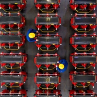 Employees work on a dry-type transformer production line at an electrical production factory in Haian in eastern China\'s Jiangsu province on Jan. 4. China’s role as factory to the world was enhanced last year as it pumped out face masks, medical equipment and work-from-home gear. | STR / VIA AFP-JIJI