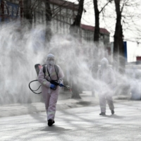 People spray disinfectant on a street in the Gaocheng district, which was declared a high-risk area for COVID-19, in Shijiazhuang in northern China\'s Hebei province. | AFP-JIJI