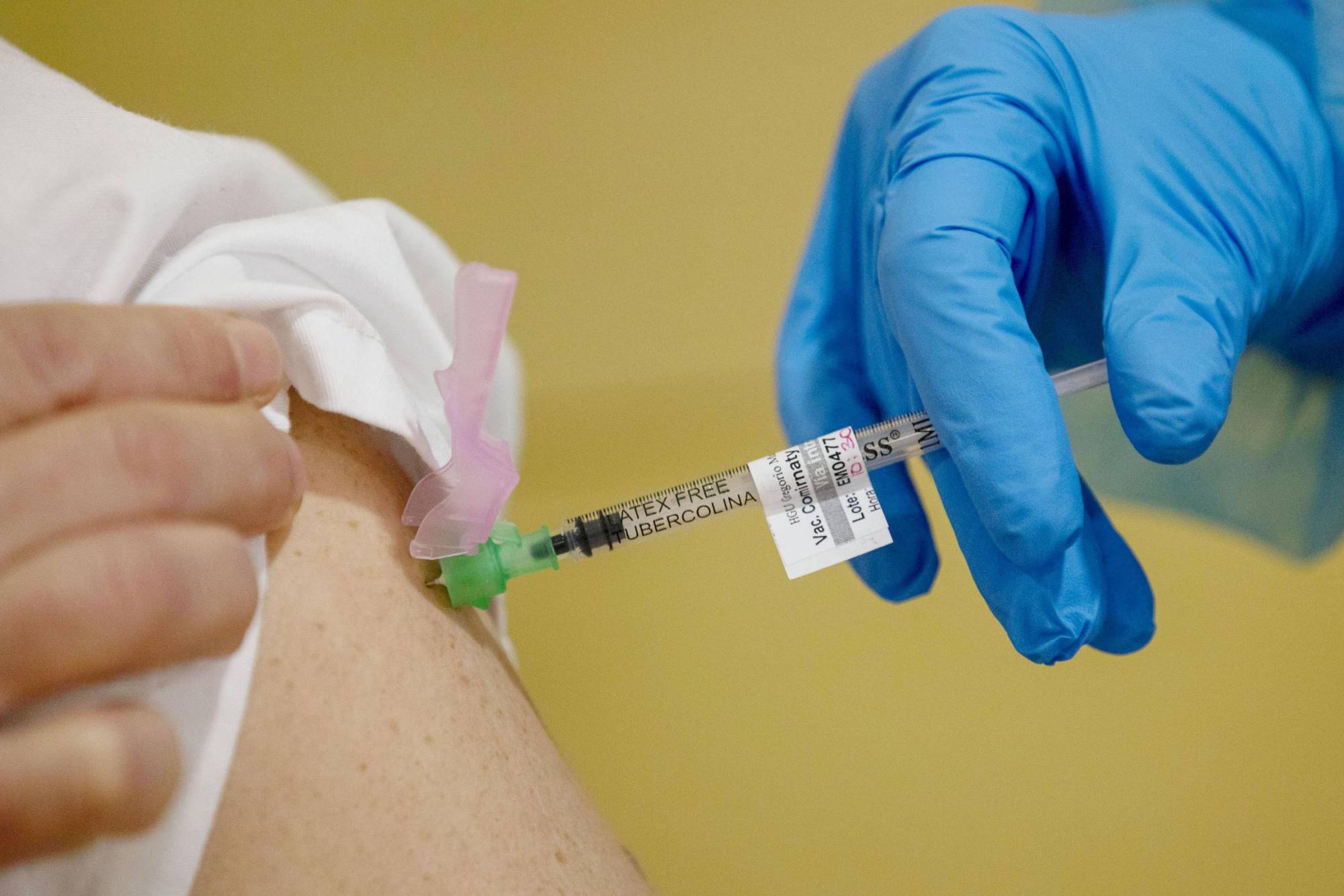 A person receives a shot of a coronavirus vaccine developed by U.S. pharmaceutical company Pfizer Inc. on Thursday in Madrid. | GETTY IMAGES / VIA KYODO