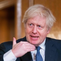U.K. Prime Minister Boris Johnson speaks during a virtual news conference in London on Friday.  | POOL / VIA AFP-JIJI