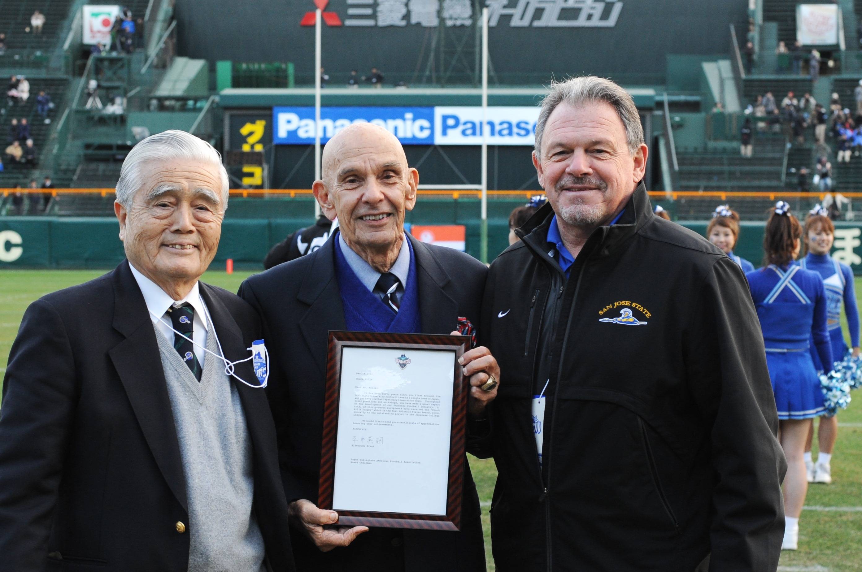 Chuck Mills (center) receives a certificate of appreciation celebrating the 40th anniversary of Utah State's 1971 exhibitions in Japan on Dec. 18, 2011, at Koshien Stadium in Nishinomiya, Hyogo Prefecture. | COURTESY OF P-TALK