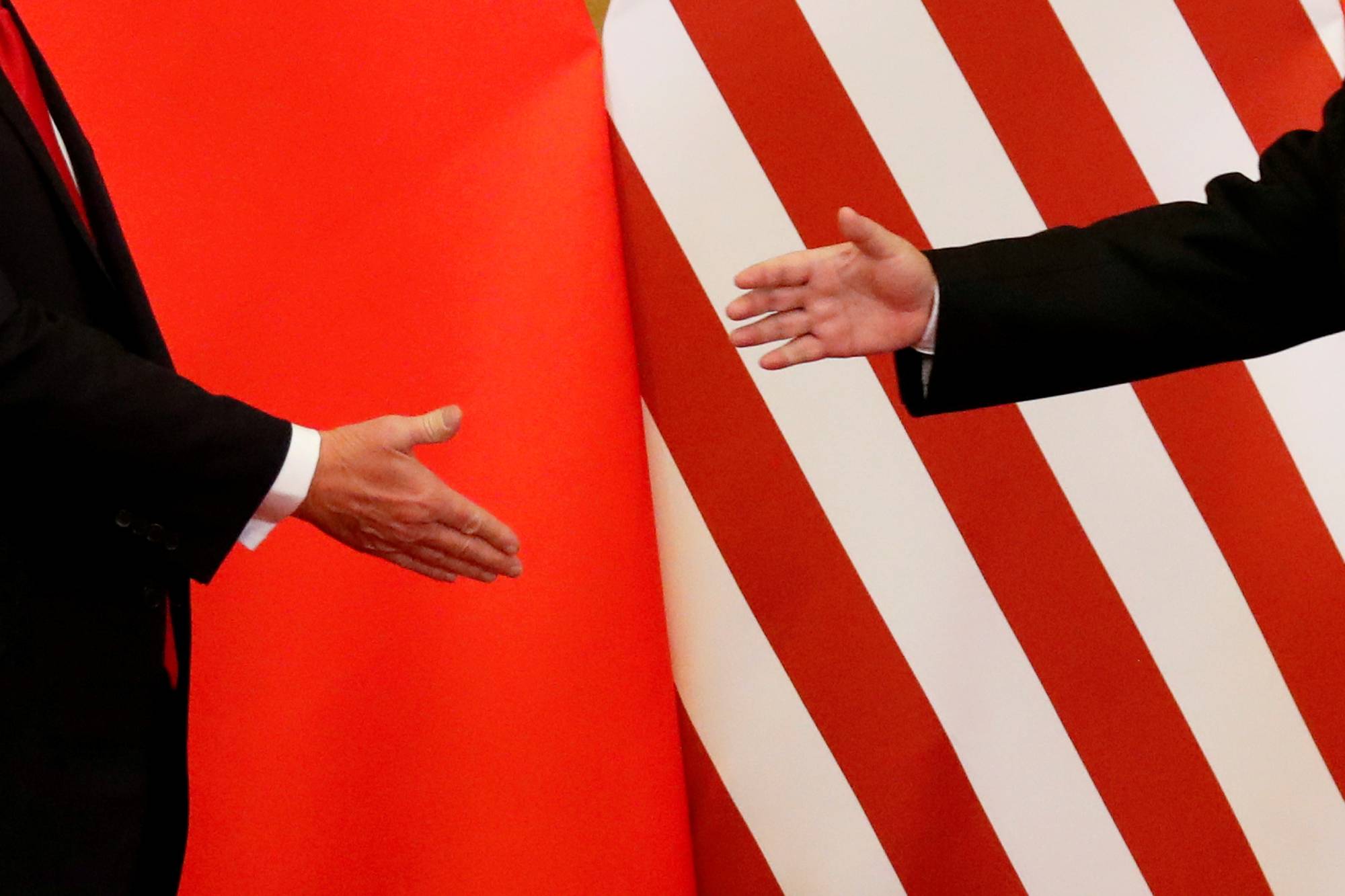 U.S. President Donald Trump and China's President Xi Jinping shake hands after making joint statements at the Great Hall of the People in Beijing on Nov. 9, 2017. | REUTERS