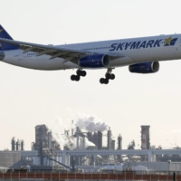 A Skymark Airlines aircraft approaches Haneda Airport in Tokyo. | REUTERS