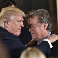 U.S. President Donald Trump congratulates senior adviser Steve Bannon in January 2017.  | AFP-JIJI