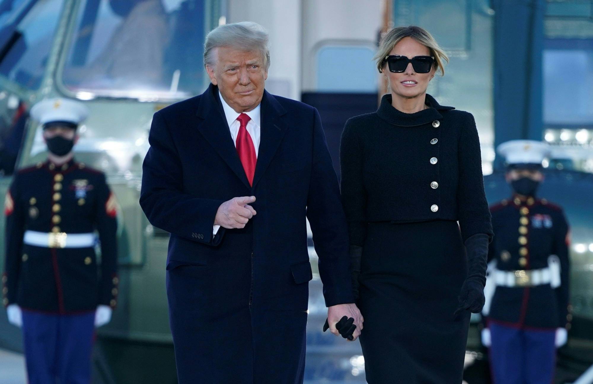 Outgoing U.S. President Donald Trump and first lady Melania Trump greet family and supporters after flying on Marine One to Joint Base Andrews in Maryland on Wednesday. Trump traveled to his Mar-a-Lago golf club residence in Palm Beach, Florida, after giving a short speech at the base. | AFP-JIJI