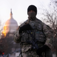 A member of the National Guard stands watch outside the U.S. Capitol at sunrise ahead of President-elect Joe Biden\'s inauguration in Washington on Wednesday. | REUTERS