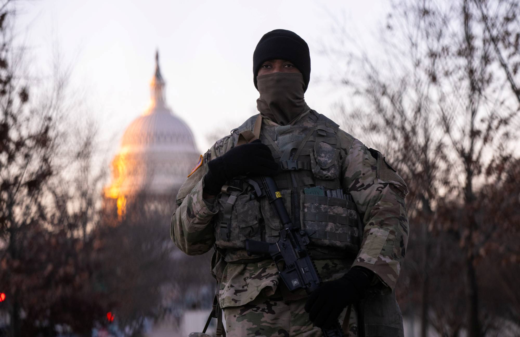 A member of the National Guard stands watch outside the U.S. Capitol at sunrise ahead of President-elect Joe Biden's inauguration in Washington on Wednesday. | REUTERS