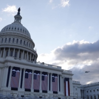 Marine One, carrying outgoing U.S. President Donald Trump, passes the Capitol before the inauguration of Joe Biden as the 46th President of the United States on the West Front of the U.S. Capitol in Washington on Wednesday. | REUTERS