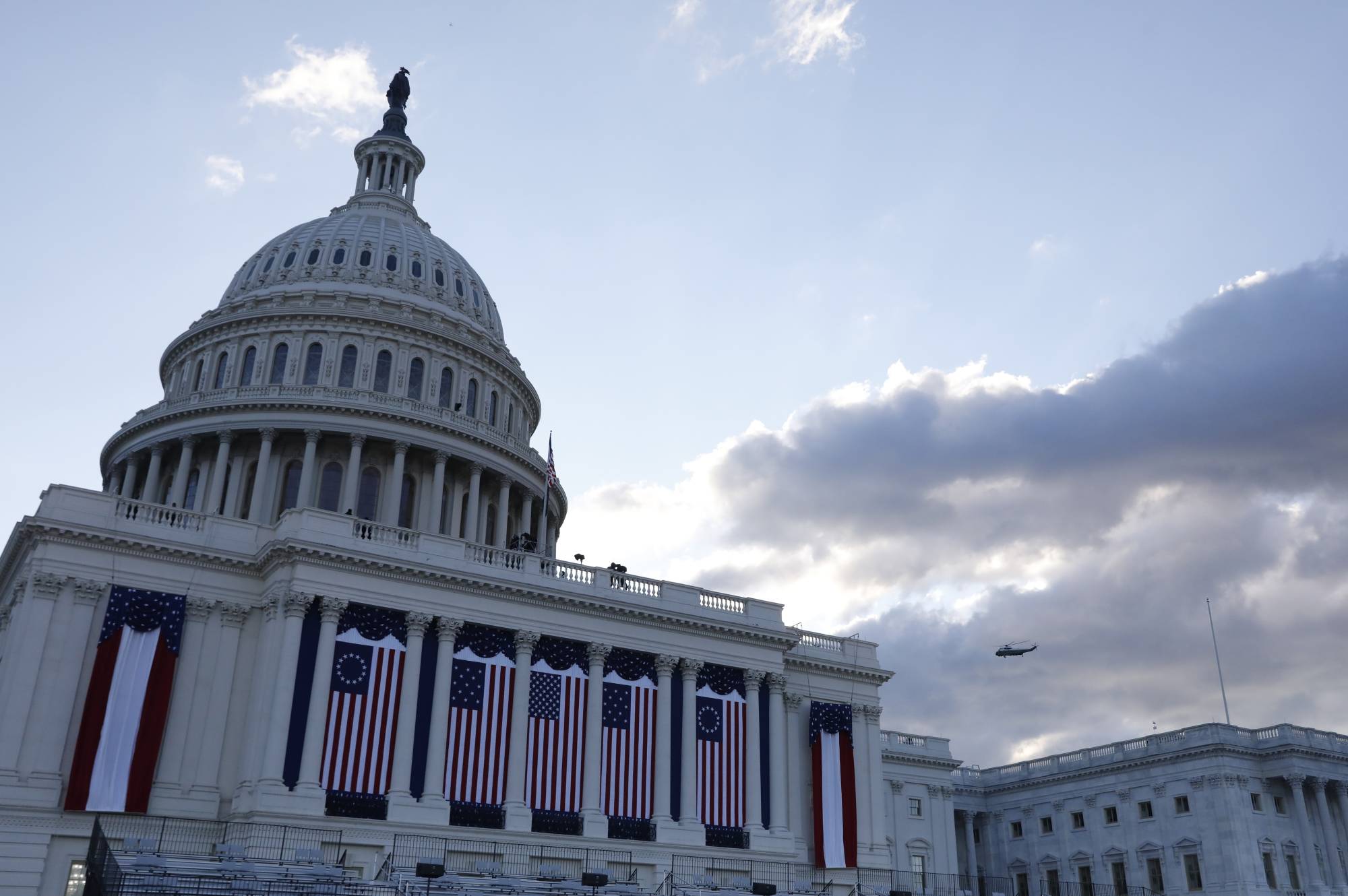Marine One, carrying outgoing U.S. President Donald Trump, passes the Capitol before the inauguration of Joe Biden as the 46th President of the United States on the West Front of the U.S. Capitol in Washington on Wednesday. | REUTERS