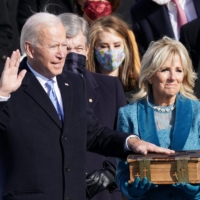 Joe Biden is sworn in as the 46th president of the United States as his wife, Jill, holds a bible on the West Front of the U.S. Capitol in Washington on Wednesday. | REUTERS