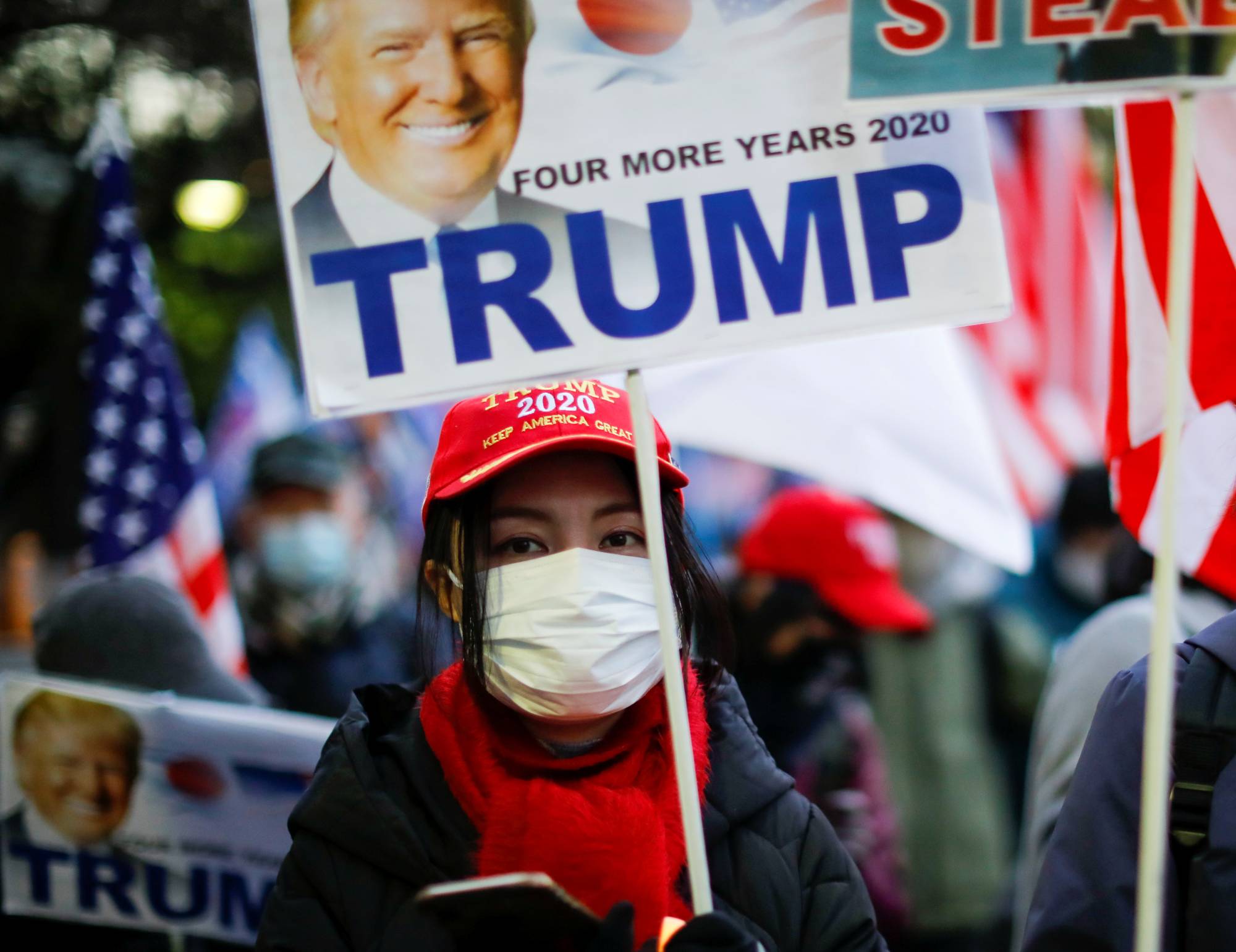Supporters of U.S. President Donald Trump protest ahead of the inauguration of President-elect Joe Biden, in Tokyo's Ginza district on Wednesday. | REUTERS