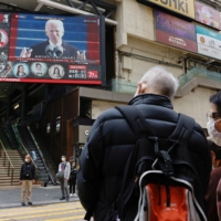 A TV screen in Hong Kong on Thursday shows news of U.S. President Joe Biden\'s inauguration. | REUTERS