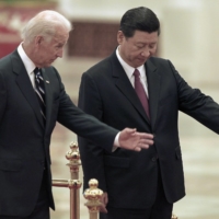 China\'s then-vice president, Xi Jinping, invites Joe Biden, then the U.S. vice president, to view an honor guard during a welcoming ceremony inside Beijing\'s Great Hall of the People in August 2011. | POOL / VIA REUTERS