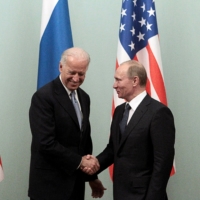 Then-U.S. Vice President Joe Biden shakes hands with then-Russian Prime Minister Vladimir Putin during a meeting in Moscow in March 2011. | REUTERS