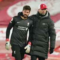 Liverpool manager Jurgen Klopp (right) consoles goalkeeper Alisson Becker after the team\'s defeat to Burnley on Tuesday in Liverpool, England. | POOL / VIA AFP-JIJI