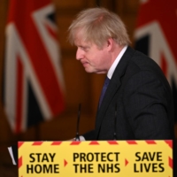 British Prime Minister Boris Johnson leaves after speaking at a coronavirus news conference at No. 10 Downing Street in London on Friday.  | POOL / VIA REUTERS