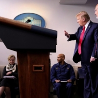 During a briefing in April last year, U.S. President Donald Trump directs White House coronavirus task force members, including CDC Director Robert Redfield (right).  | REUTERS