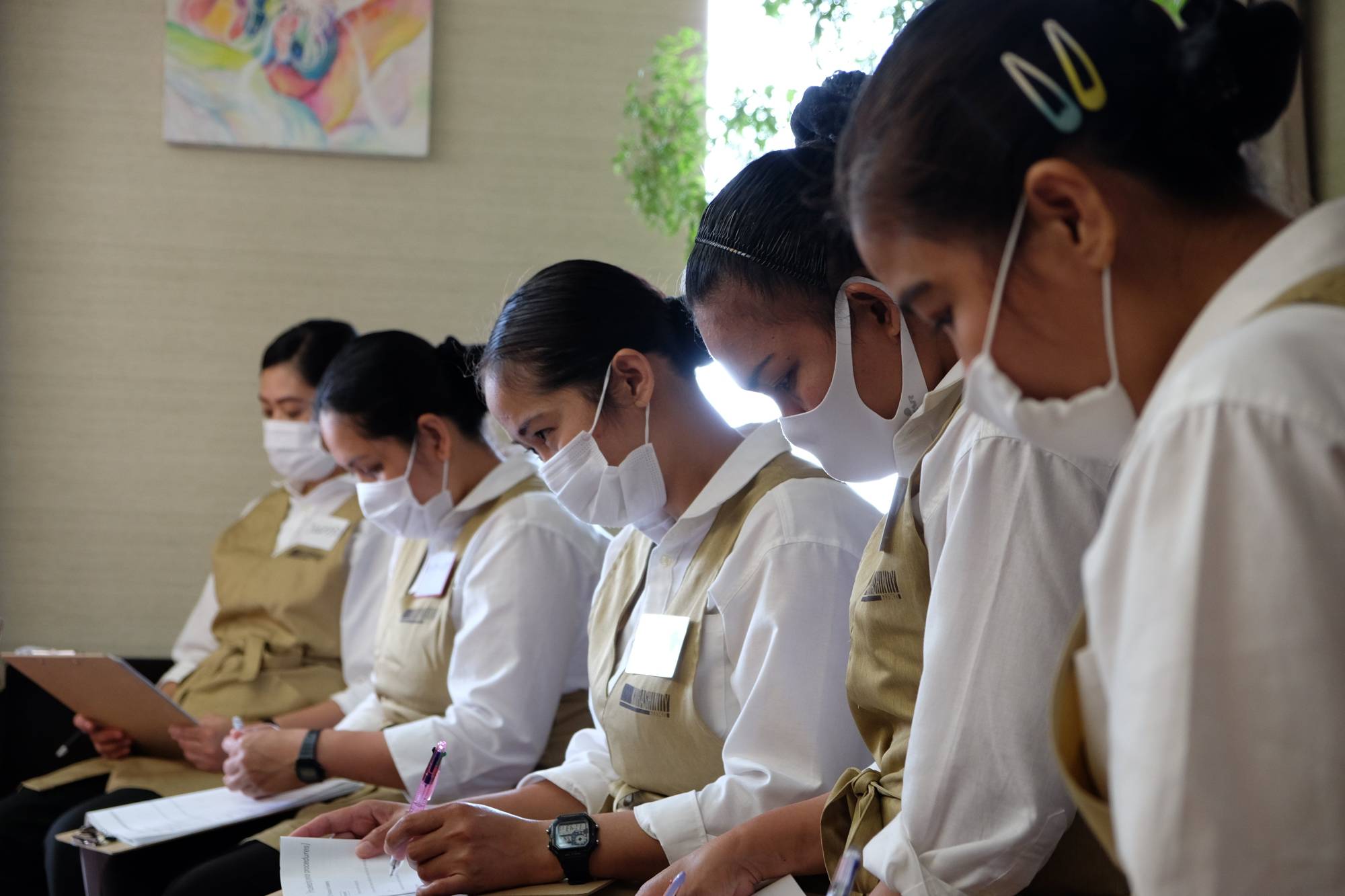 Homework: Women from the Philippines take part in an orientation after being recruited as housekeepers through the Kurashinity program. | KYODO