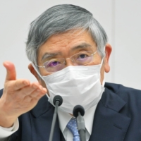 Bank of Japan Gov. Haruhiko Kuroda takes a question during a news conference in Tokyo on Thursday. | POOL / VIA BLOOMBERG
