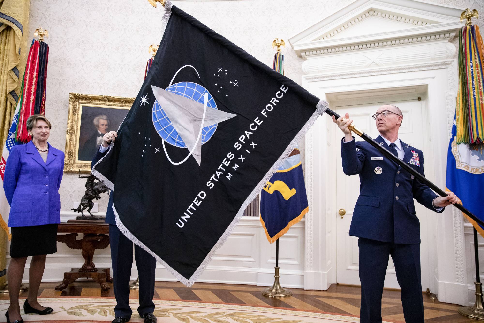 Gen. Jay Raymond, chief of space operations, presents then-U.S. President Donald Trump with the official flag of the space force in the Oval Office at the White House in May last year. | SAMUEL CORUM / THE NEW YORK TIMES